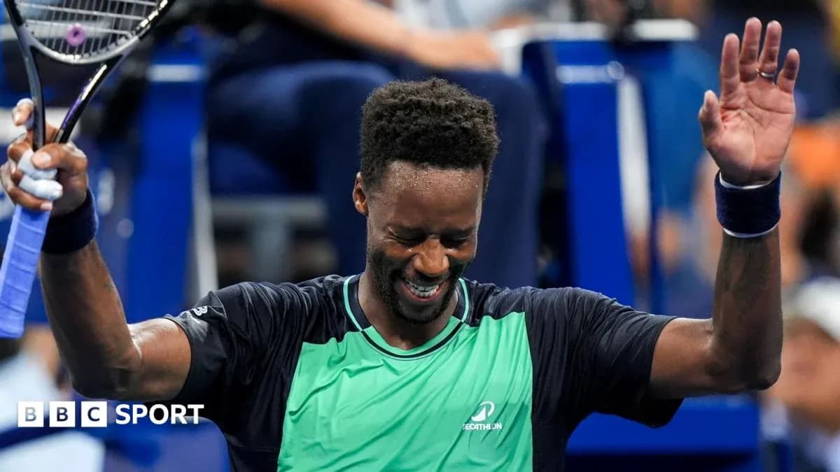Tennis player celebrating victory with raised arms