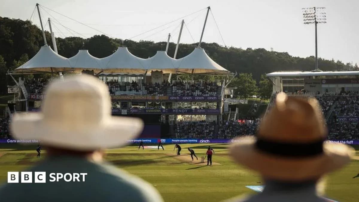 Cricket match with spectators at stadium