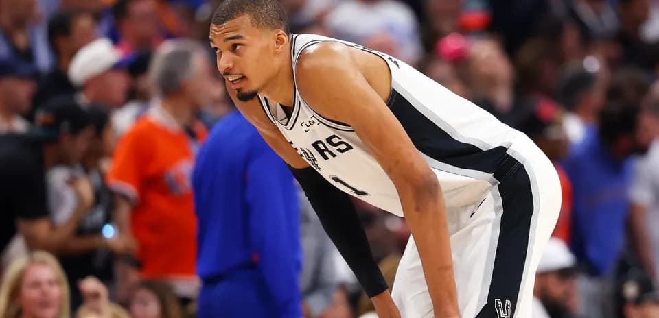 Player in Spurs jersey during game action