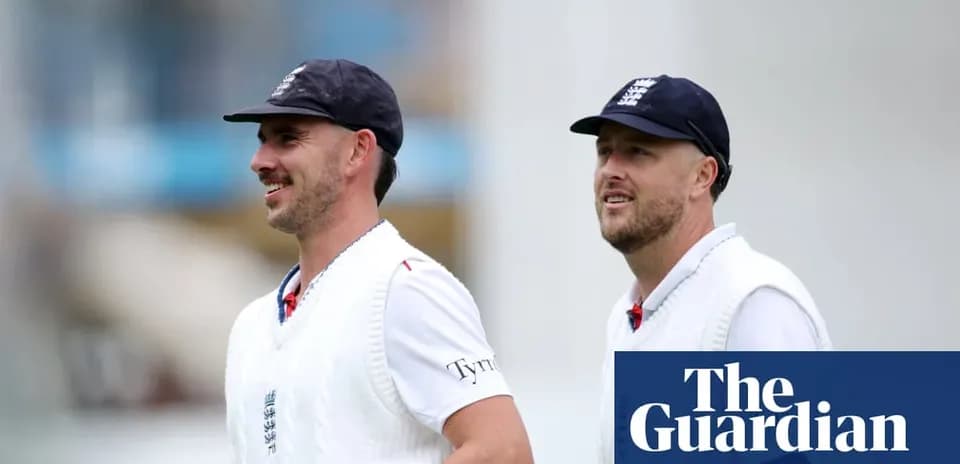 Two England cricketers walking on the field