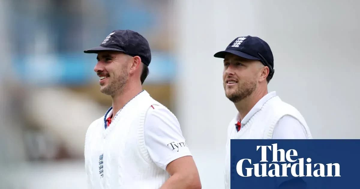 Two England cricketers walking on the field