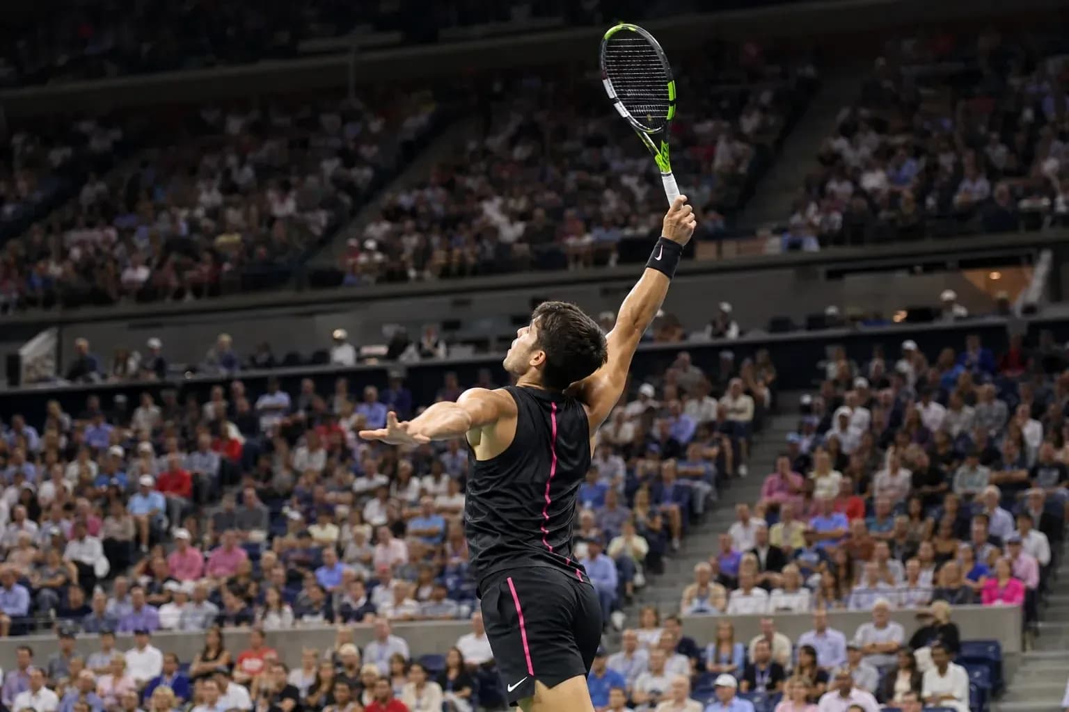 Player serving during a tennis match in stadium