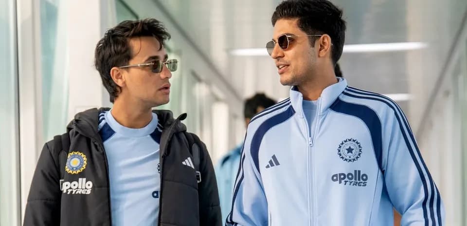 Two players walking in sports attire at venue