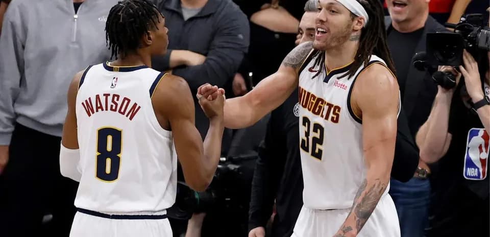 Two basketball players celebrating during game moment