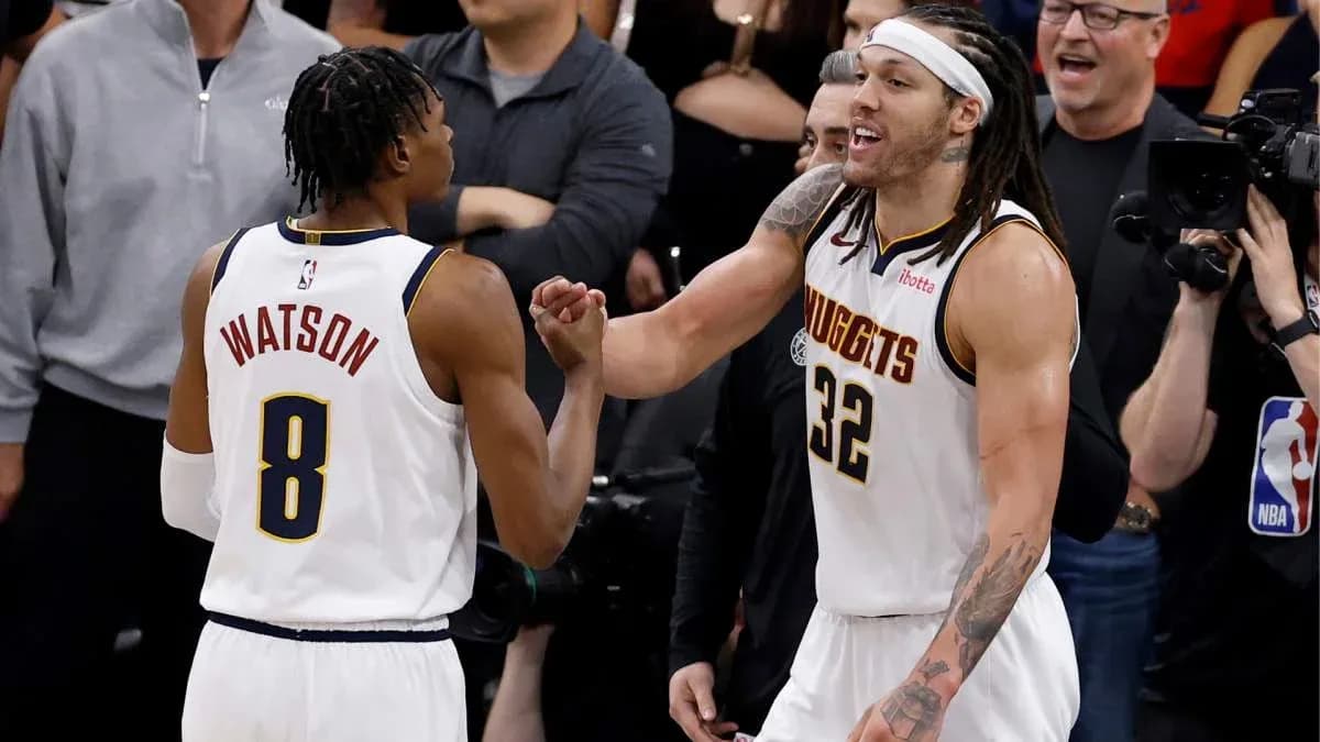 Two basketball players celebrating during game moment
