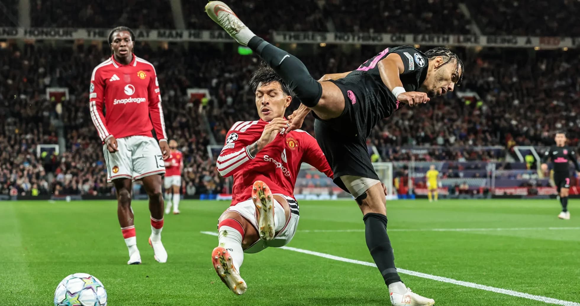 Player tackling opponent during match at Old Trafford
