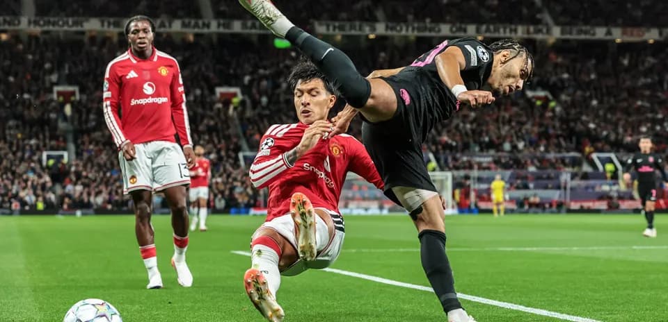 Player tackling opponent during match at Old Trafford