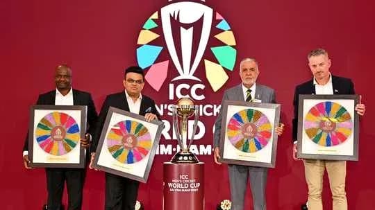 Four officials holding framed artworks at ICC event