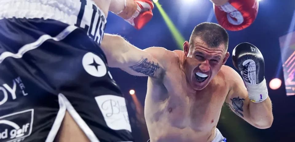Boxer throwing a punch in the ring