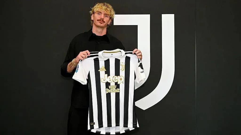 Player holding Juventus jersey at announcement event