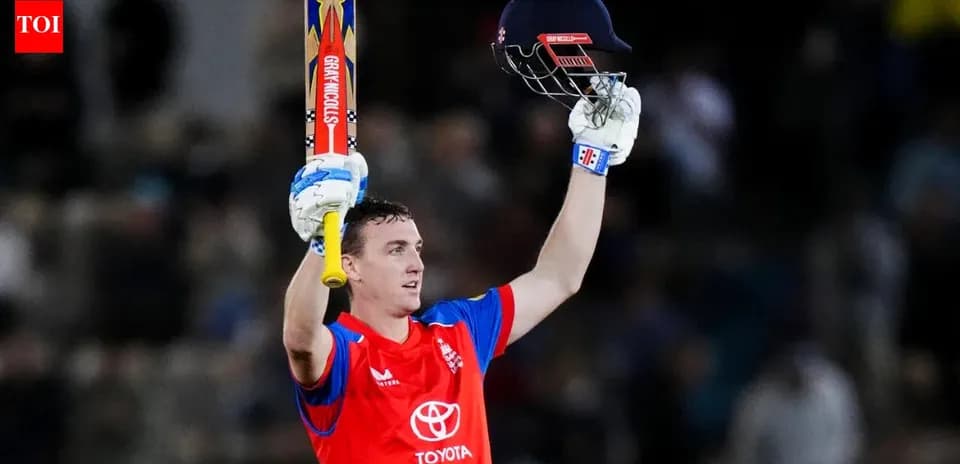 Batsman celebrating century with raised bat and helmet