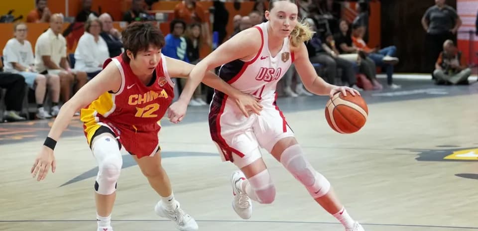 USA player dribbling past China defender in game