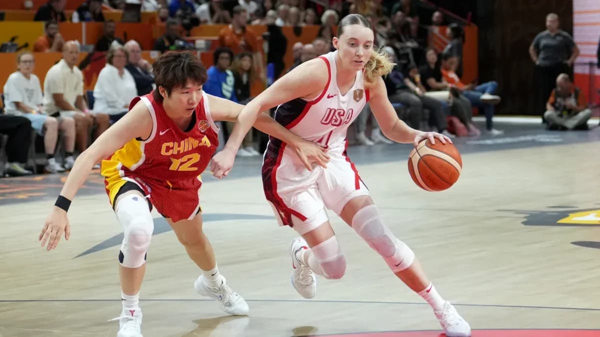 USA player dribbling past China defender in game
