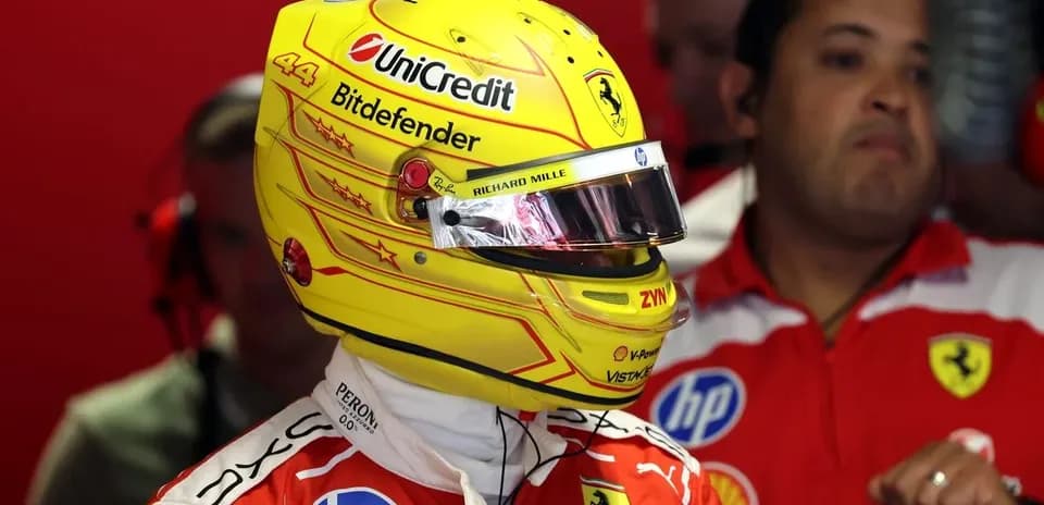 Driver wearing helmet in Ferrari garage before race