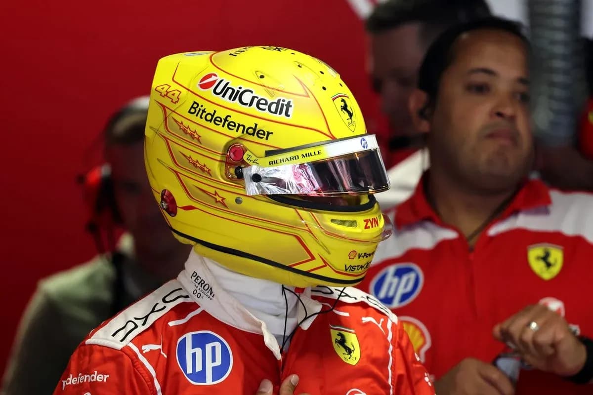 Driver wearing helmet in Ferrari garage before race