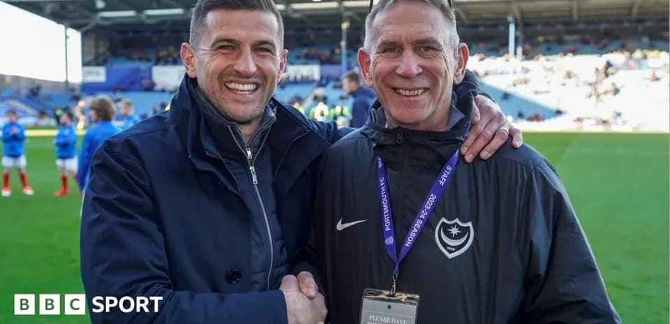 Two men shaking hands on the pitch