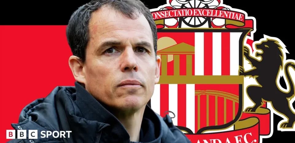 Coach in front of Sunderland AFC logo background
