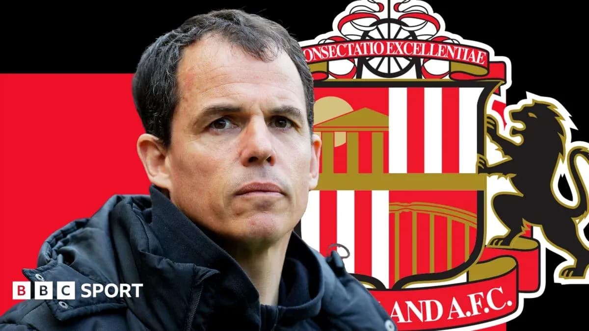 Coach in front of Sunderland AFC logo background