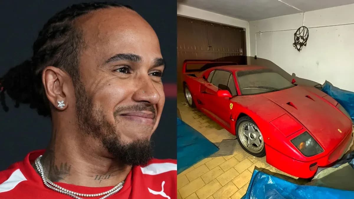 Lewis Hamilton smiling next to a covered Ferrari