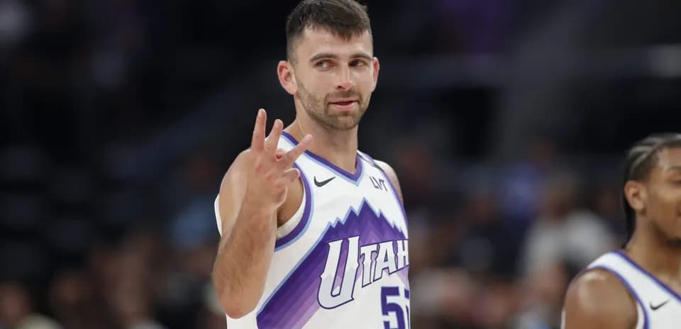 Player gesturing three points during basketball game