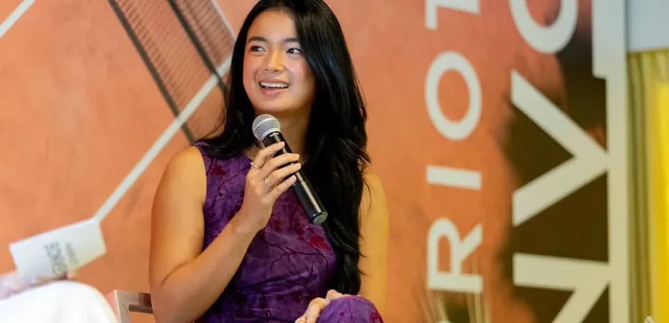 Person speaking into microphone at event
