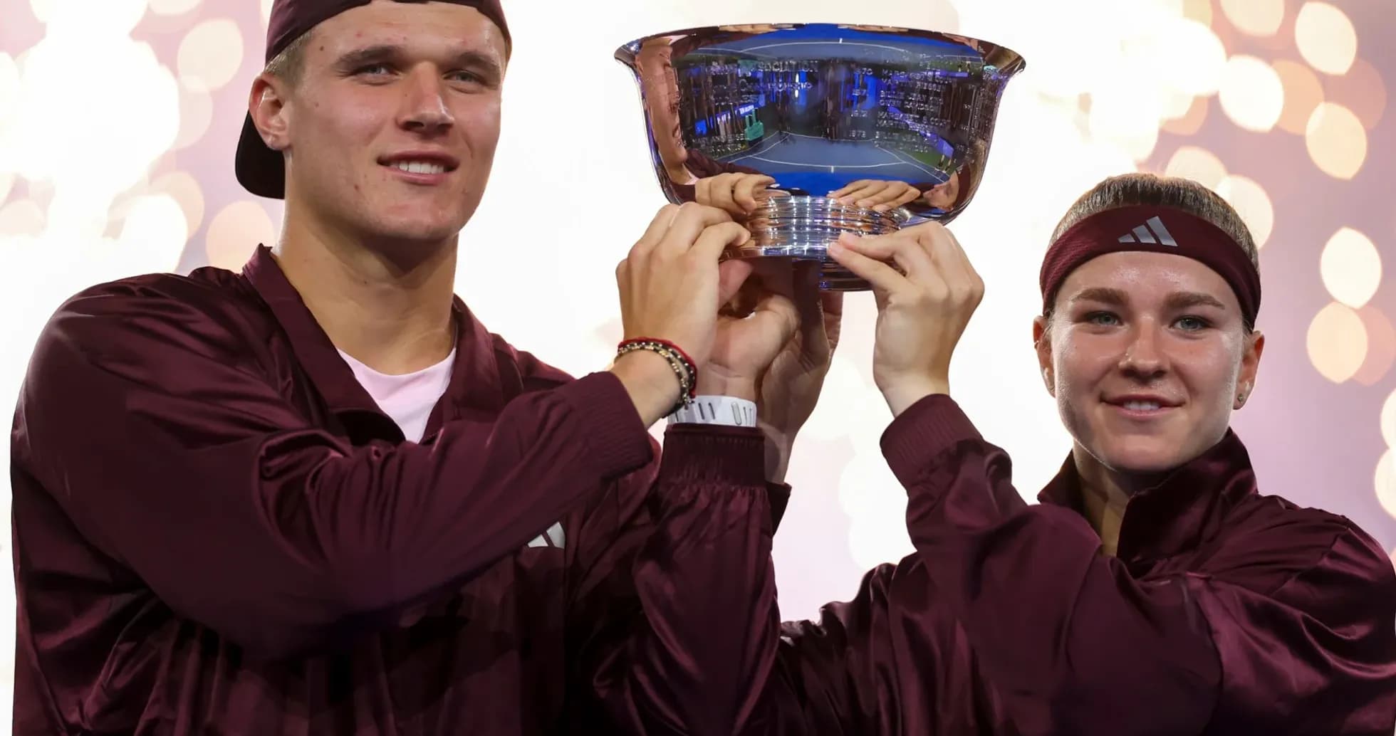 Athletes celebrating victory with trophy during ceremony