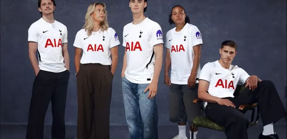 Five individuals wearing Tottenham Hotspur jerseys