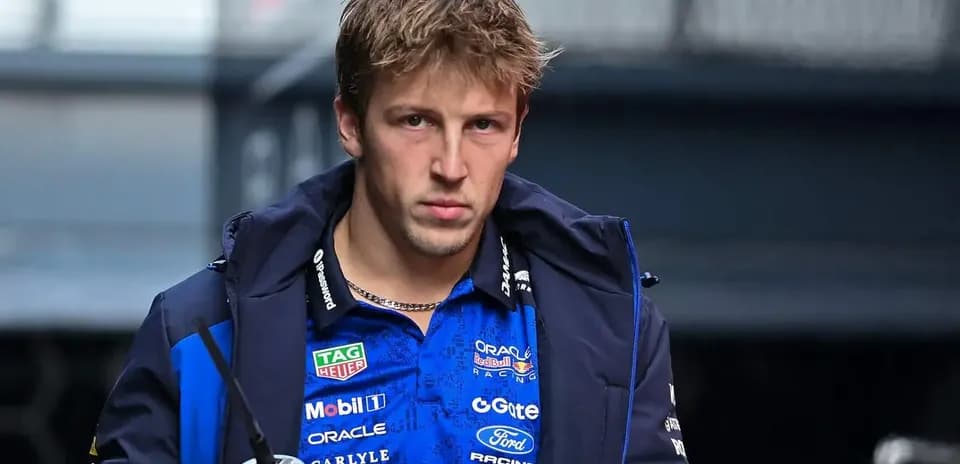 Driver walking in team jacket before race