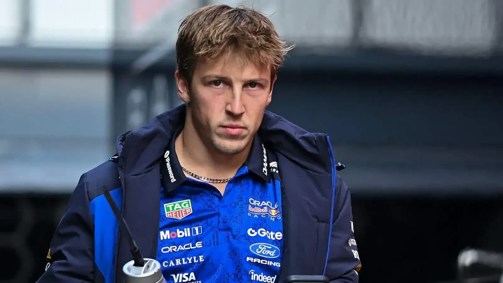 Driver walking in team jacket before race
