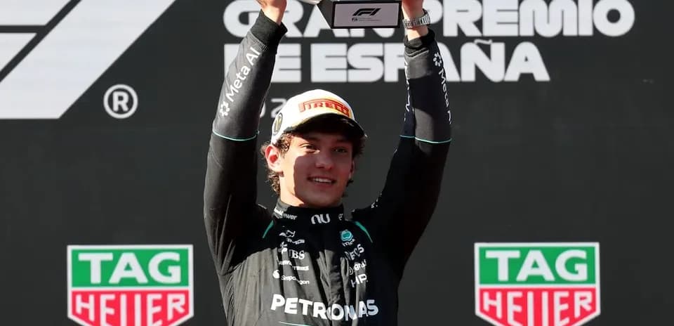 Driver celebrating victory at Formula 1 podium