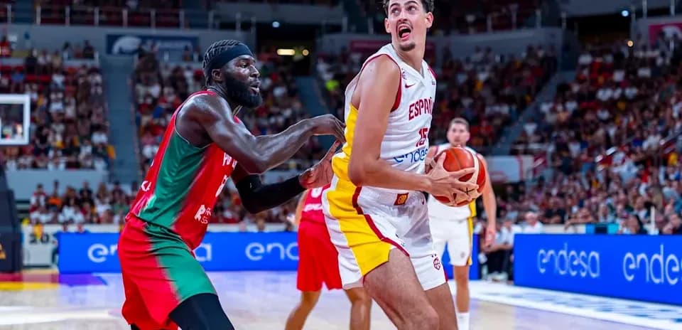 Player from Spain holding ball, defender reaching for him