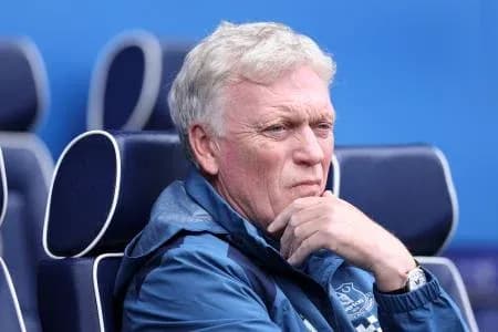 Manager sitting on bench during match