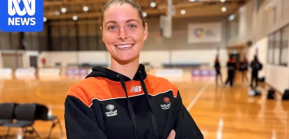 Player smiling in netball training facility