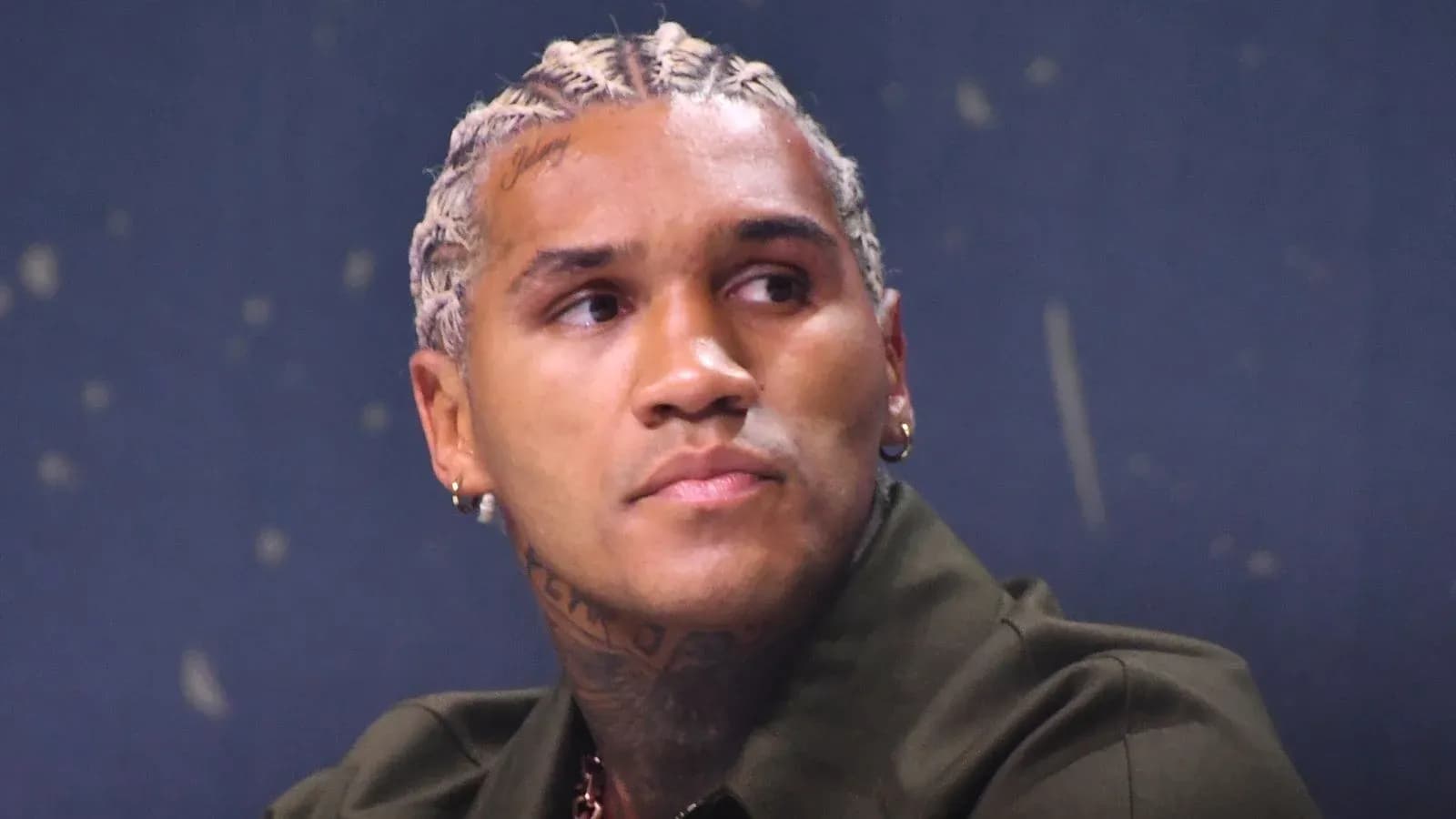 Athlete with braided hair at a press event