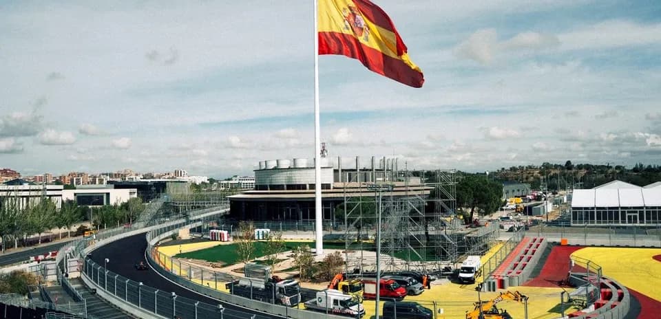 Spanish flag flying over a racetrack under construction