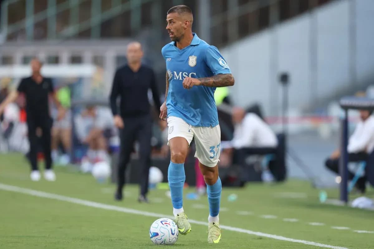 Player in blue kit running with soccer ball