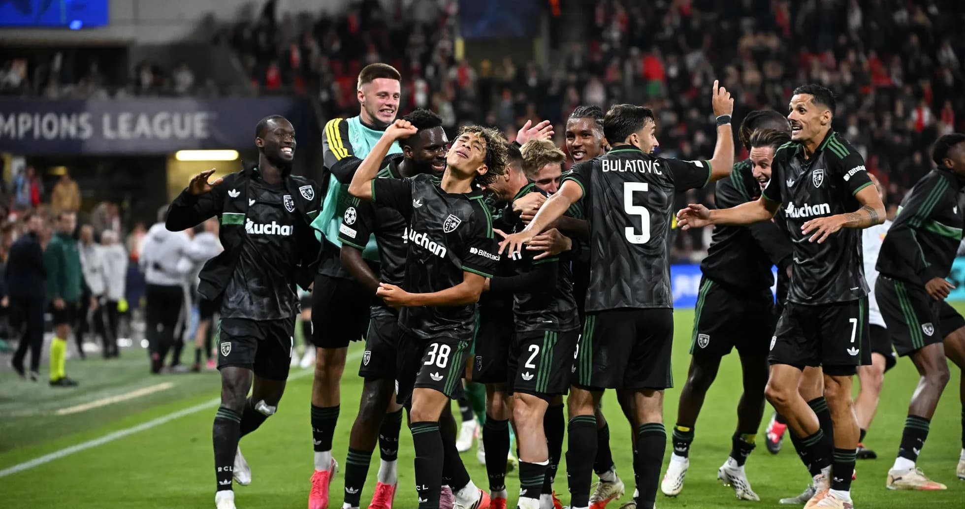 Players celebrating a goal during Champions League match