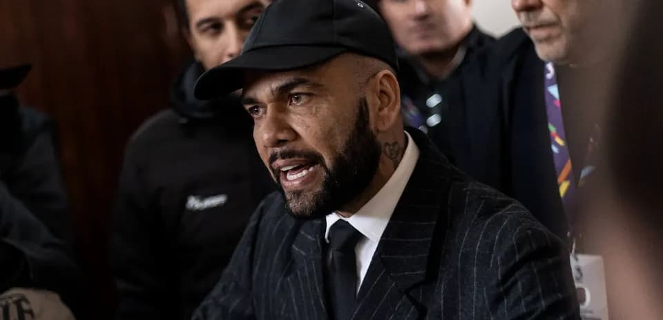 Man in a suit speaking to a crowd