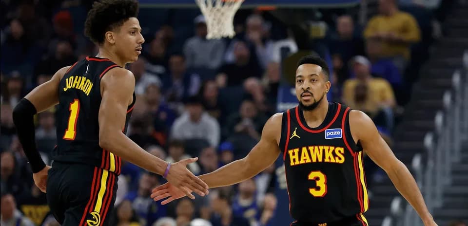 Two Atlanta Hawks players celebrating a play
