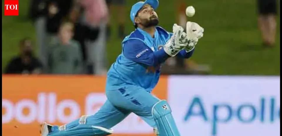 Wicketkeeper diving to catch a cricket ball