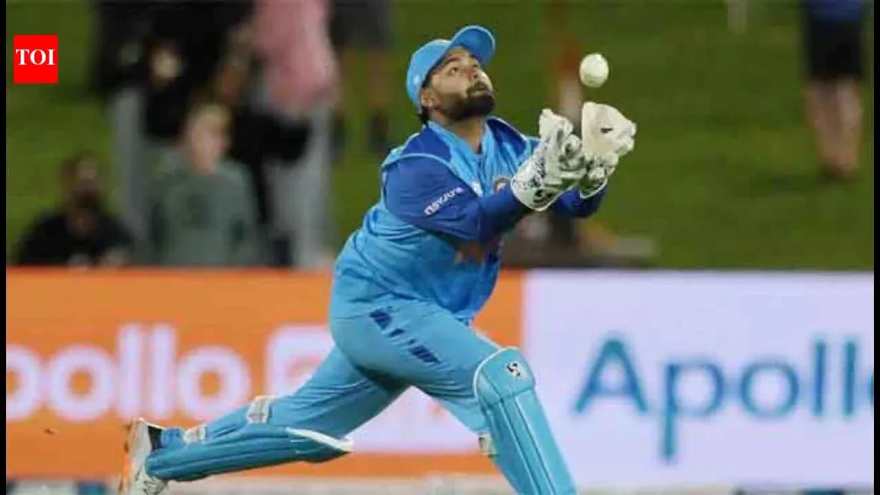 Wicketkeeper diving to catch a cricket ball