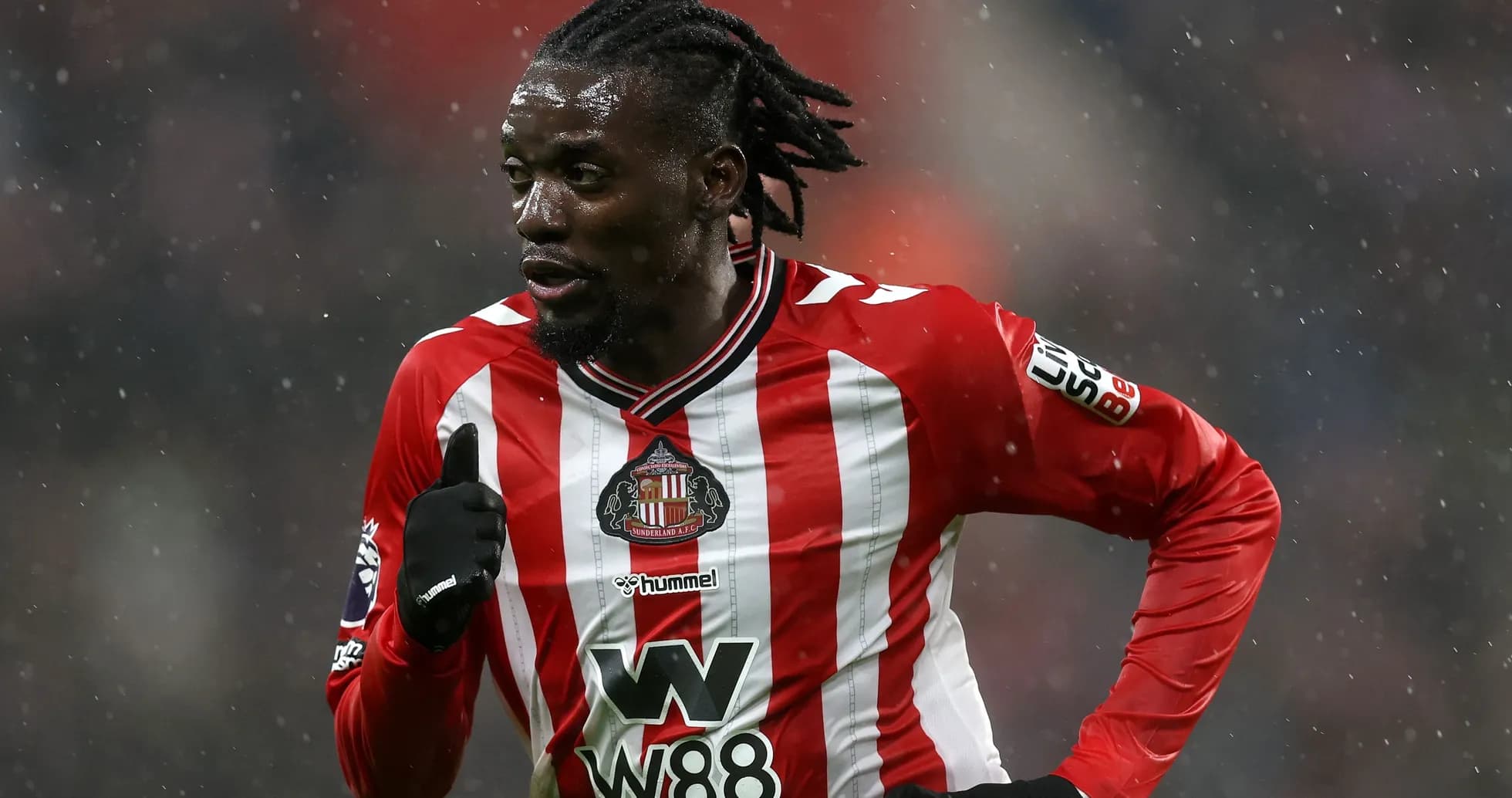 Sunderland player running in the rain during match