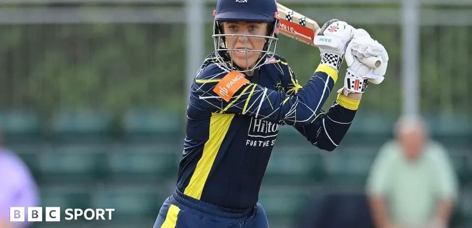 Cricketer preparing to bat during a match