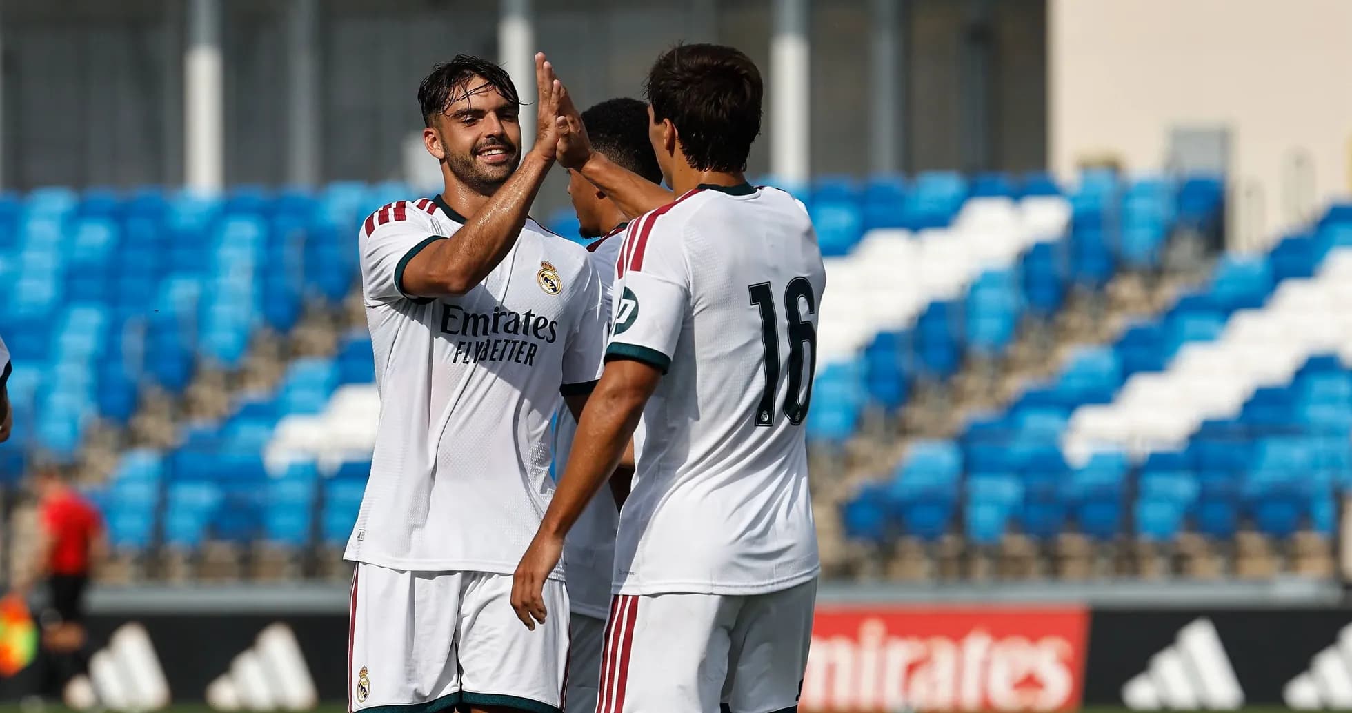 Players celebrating with a high five during match