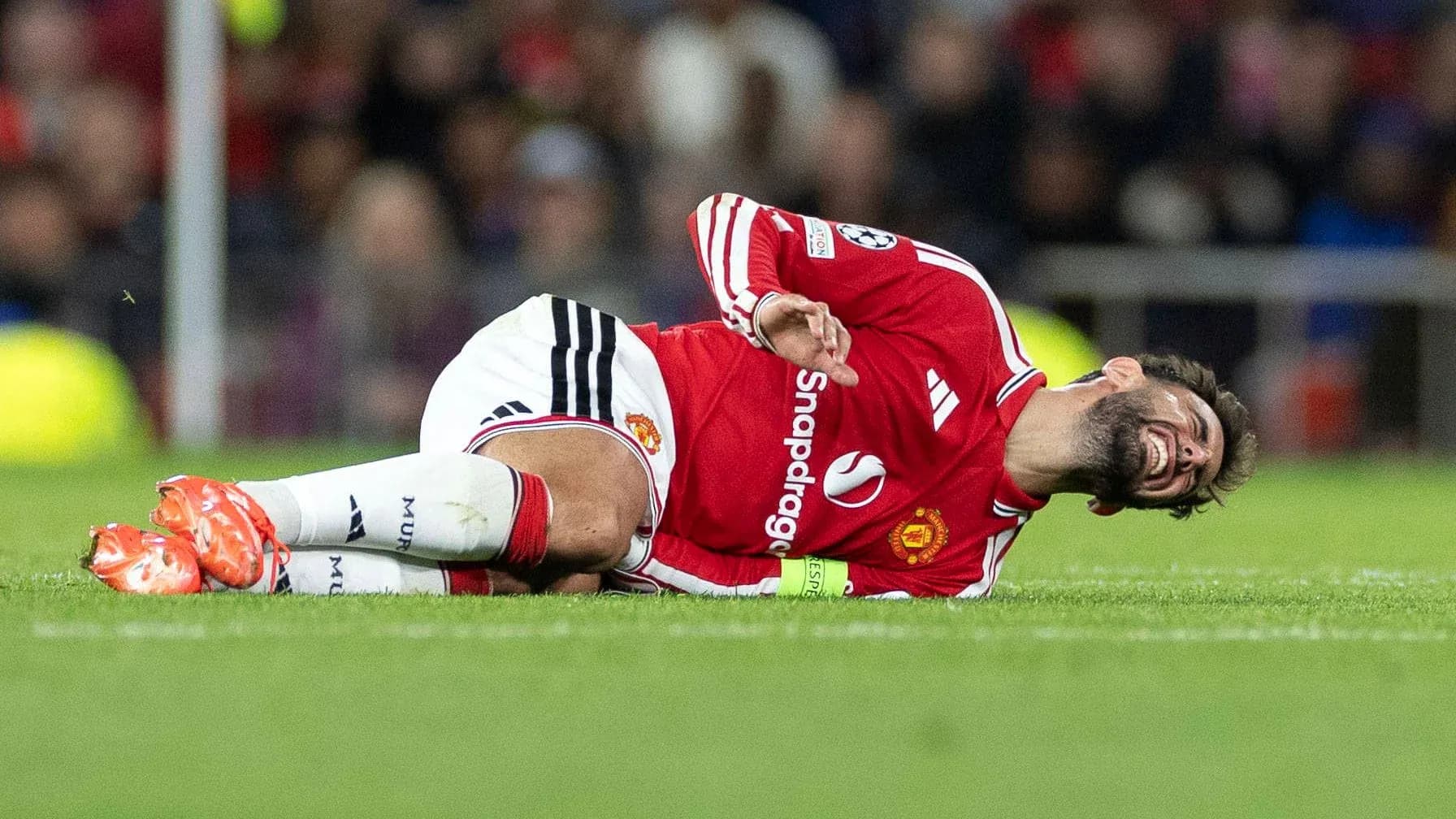 Player lying on the pitch in distress during match