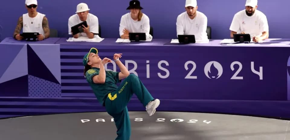 Athlete performing during Paris 2024 event with judges