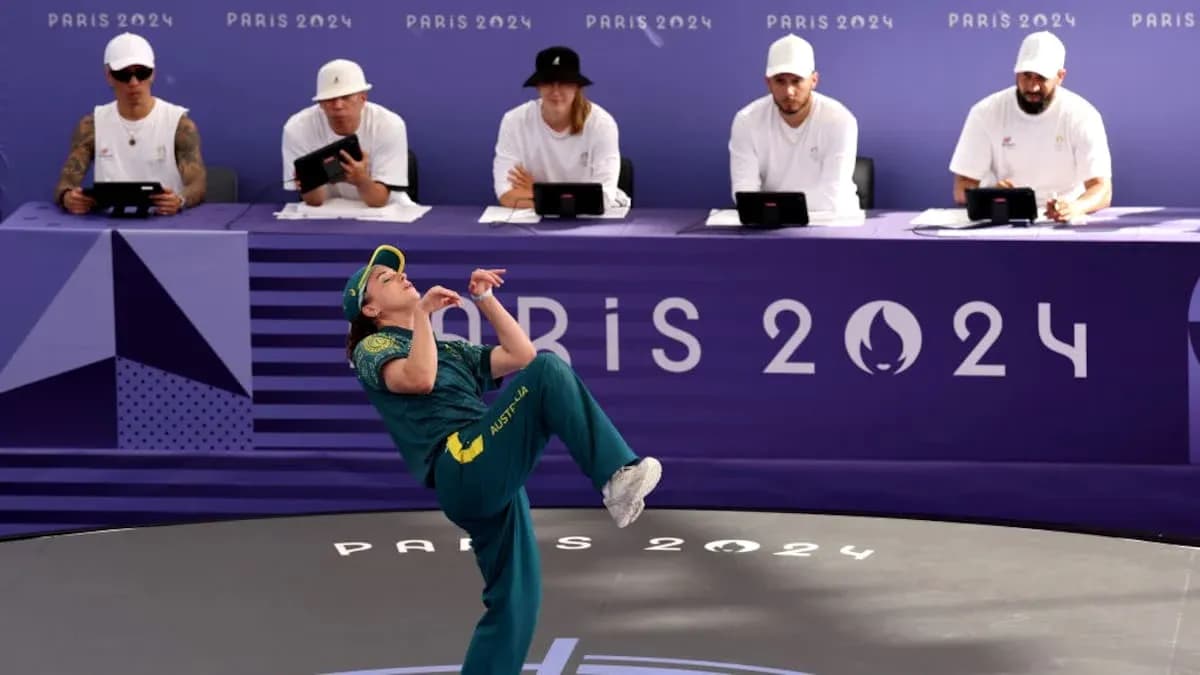 Athlete performing during Paris 2024 event with judges