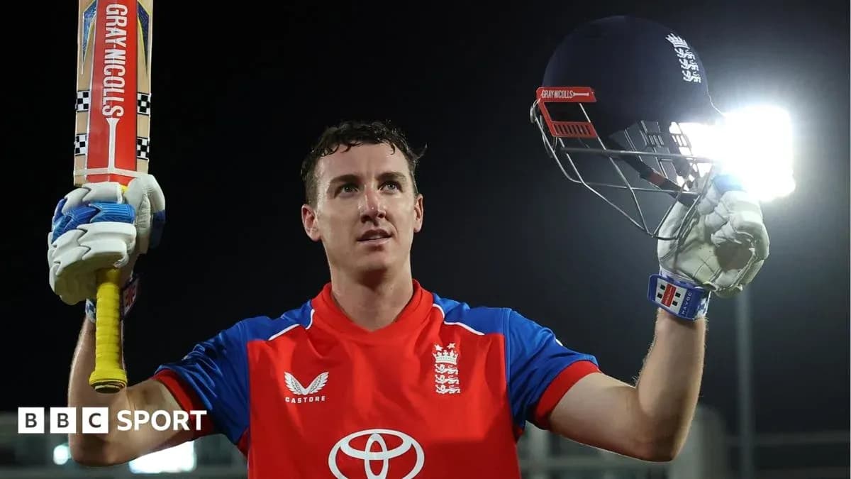 Batsman celebrating with bat and helmet raised