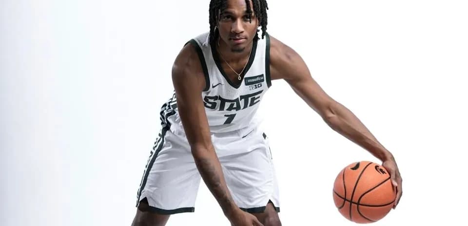 Basketball player dribbling with ball in studio