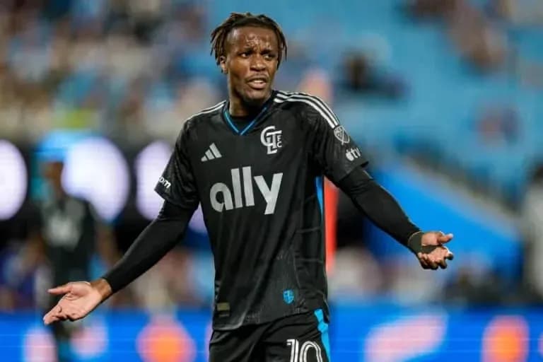 Player gesturing during match in black uniform